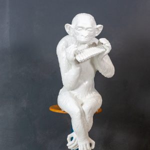 Large sitting ceramic chimpanzee  playing the panpipes